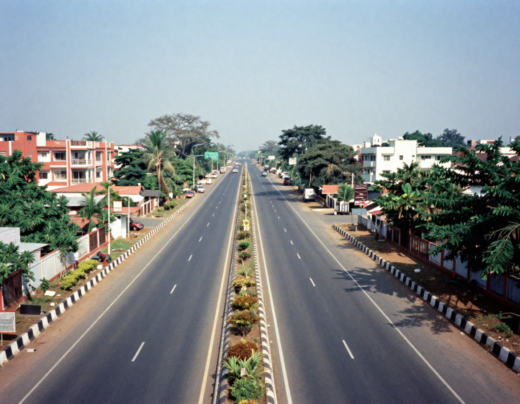 Wide highway development near residential neighborhoods indicating high appreciation plots near GST Road Chennai