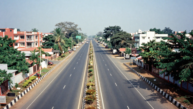 Wide highway development near residential neighborhoods indicating high appreciation plots near GST Road Chennai