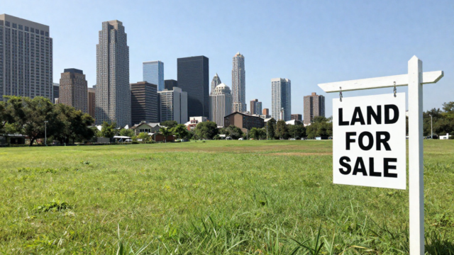 Aerial view of premium DTCP approved residential plots for sale near Vandalur, Chennai, featuring wide black-top roads and lush green surroundings near Arignar Anna Zoological Park.