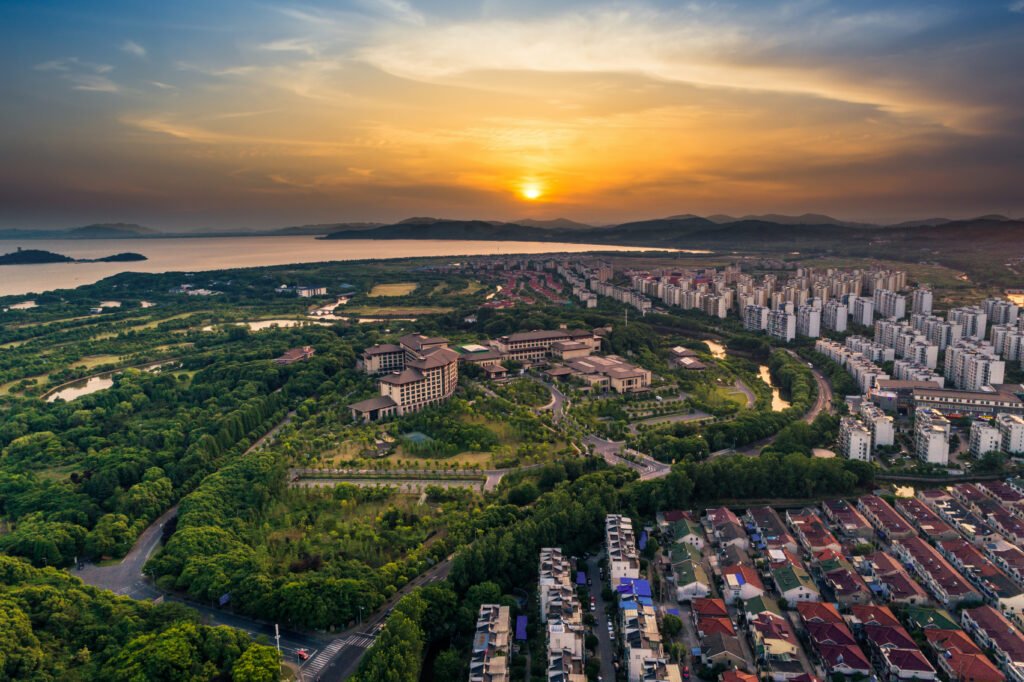 Aerial view of a well-planned residential area with green spaces and apartment complexes, highlighting residential plots with high resale value in Chennai