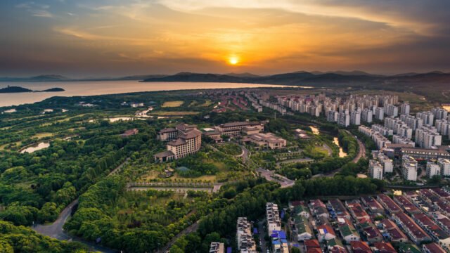 Aerial view of a well-planned residential area with green spaces and apartment complexes, highlighting residential plots with high resale value in Chennai